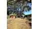 Large backyard with mature tree and storage shed at 620 Se Oleander Se Dr, Winter Haven, FL 33880