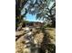 Exterior view of a one-story home with mature trees that are providing some shade in the backyard at 620 Se Oleander Se Dr, Winter Haven, FL 33880