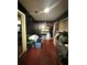 Dark bedroom with overflowing piles of clothes and miscellaneous items throughout the room at 620 Se Oleander Se Dr, Winter Haven, FL 33880