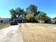 A single-story home with a spacious driveway and mature trees at 620 Se Oleander Se Dr, Winter Haven, FL 33880