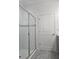Bathroom featuring glass shower doors and neutral tile at 625 Disa Dr, Davenport, FL 33837