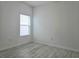 Bedroom featuring light, neutral walls and flooring and window at 625 Disa Dr, Davenport, FL 33837