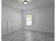 Light and airy bedroom with wood-look tile flooring and natural light from the window at 625 Disa Dr, Davenport, FL 33837