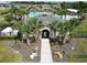 The community clubhouse is flanked by palm trees and accessible by sidewalk at 625 Disa Dr, Davenport, FL 33837