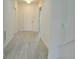Bright and spacious entryway with light gray wood floors and white walls leading to other rooms at 625 Disa Dr, Davenport, FL 33837