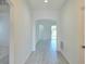 Bright entryway featuring light gray wood floors, white walls, and an arched doorway at 625 Disa Dr, Davenport, FL 33837