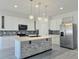Bright kitchen boasts a large island, stainless steel appliances, and modern pendant lighting at 625 Disa Dr, Davenport, FL 33837
