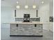 Bright kitchen features a large center island with quartz countertop and stylish pendant lights at 625 Disa Dr, Davenport, FL 33837