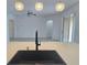 The kitchen overlooks the open-concept living area and features a modern black sink and faucet at 625 Disa Dr, Davenport, FL 33837