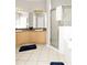 Bathroom featuring double sinks, a large mirror, tile floors and a glass-enclosed shower at 662 Orista Dr, Davenport, FL 33897