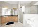 Bathroom featuring double sinks, a large mirror, tile floors and a glass-enclosed shower at 662 Orista Dr, Davenport, FL 33897