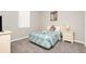 Cozy bedroom with a comfortable bed, nightstand, and carpeted floor at 662 Orista Dr, Davenport, FL 33897