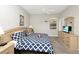 Bright bedroom featuring a blue and white patterned bedspread, ceiling fan and a TV for relaxing evenings at 662 Orista Dr, Davenport, FL 33897