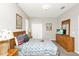 Cozy bedroom featuring a wood dresser, a comfy queen-sized bed and carpet flooring at 662 Orista Dr, Davenport, FL 33897