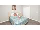 Comfortable bedroom featuring a cozy bed, nightstand, and closet at 662 Orista Dr, Davenport, FL 33897