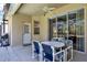 Inviting covered patio with a ceiling fan and patio set, ideal for outdoor dining and relaxation by the pool at 662 Orista Dr, Davenport, FL 33897