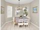 Cozy dining room with tile floors, bright windows with vertical blinds, and a chandelier over the dining table at 662 Orista Dr, Davenport, FL 33897