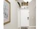 Bright entryway featuring tile floors, and decor accents, including a decorative painting and transom window above the front door at 662 Orista Dr, Davenport, FL 33897