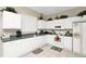 Functional kitchen with white cabinetry, green countertops, and essential appliances; decorated with plants and accessories at 662 Orista Dr, Davenport, FL 33897