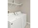 Bright laundry room featuring a modern washer and dryer with wire shelving at 662 Orista Dr, Davenport, FL 33897