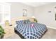 Comfortable main bedroom featuring carpeted floors, a ceiling fan, side tables, and a plush bed with decorative pillows at 662 Orista Dr, Davenport, FL 33897