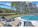 A screened-in pool area features lounge chairs with a view of the backyard at 662 Orista Dr, Davenport, FL 33897