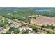 Aerial view of home in a rural setting with lakes, fields, and a nearby railroad track at 6925 3Rd St, Mulberry, FL 33860
