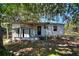 View of the home's back exterior and backyard at 6925 3Rd St, Mulberry, FL 33860
