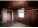 Bedroom featuring wood paneled walls, a window, and a closet with shelves at 6925 3Rd St, Mulberry, FL 33860