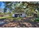 Charming one-story home with mature trees, a screened-in porch, and ample space at 6925 3Rd St, Mulberry, FL 33860