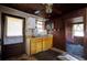 A compact kitchen with wooden cabinets, sink, and doorway for renovations at 6925 3Rd St, Mulberry, FL 33860