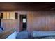 Spacious living room with wood walls, ceiling, and cabinets awaiting personalized renovations at 6925 3Rd St, Mulberry, FL 33860
