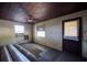 A room with natural light from two windows and access to the outside via a wooden door at 6925 3Rd St, Mulberry, FL 33860