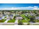 Aerial view of a residential neighborhood highlighting well-kept homes, green spaces, and organized street layouts at 716 Maderia Ct, Kissimmee, FL 34758