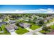 Neighborhood aerial view featuring neatly arranged homes, green lawns, and tree-lined streets in a peaceful setting at 716 Maderia Ct, Kissimmee, FL 34758