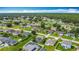 Aerial shot of a neighborhood showcasing solar panels and green spaces, merging sustainability with community living at 716 Maderia Ct, Kissimmee, FL 34758