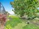 Spacious backyard with a hammock under a mature tree, offering a peaceful retreat at 716 Maderia Ct, Kissimmee, FL 34758