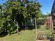 Backyard featuring a large tree, garden and lush landscaping, a tranquil retreat at 716 Maderia Ct, Kissimmee, FL 34758
