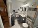 Well-organized bathroom with a vanity, mirror, and toilet with storage shelves at 716 Maderia Ct, Kissimmee, FL 34758
