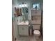 Cozy bathroom featuring a vanity, toilet, and cabinet storage at 716 Maderia Ct, Kissimmee, FL 34758
