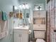 Functional bathroom with a vanity, storage cabinet, and a shower featuring a decorative seashell themed curtain at 716 Maderia Ct, Kissimmee, FL 34758