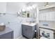 Cozy bathroom features a gray vanity, framed mirror, and a toilet with ocean-themed decoration at 716 Maderia Ct, Kissimmee, FL 34758