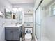Bathroom with gray vanity, brushed nickel hardware, and a glass enclosed shower at 716 Maderia Ct, Kissimmee, FL 34758