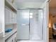 Bright bathroom featuring shower, glass door and white shelving for toiletries and accessories at 716 Maderia Ct, Kissimmee, FL 34758