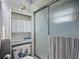 This bathroom features a stand up shower with sleek fixtures and a built in shelf for storage at 716 Maderia Ct, Kissimmee, FL 34758