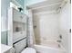 Cozy bathroom with combined shower-tub, built-in storage and charming nautical themed decorations at 716 Maderia Ct, Kissimmee, FL 34758