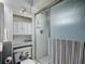 This bathroom features a stand up shower with sleek fixtures and a built in shelf for storage at 716 Maderia Ct, Kissimmee, FL 34758