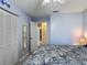 Comfortable blue bedroom with mirrored closet doors and access to a well-lit hallway and closet at 716 Maderia Ct, Kissimmee, FL 34758