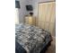 Well-lit bedroom with tiled floors, a TV, dresser, and a closet at 716 Maderia Ct, Kissimmee, FL 34758