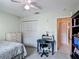 Cozy bedroom with a workspace, closet, and comfortable bed, offering a peaceful retreat at 716 Maderia Ct, Kissimmee, FL 34758